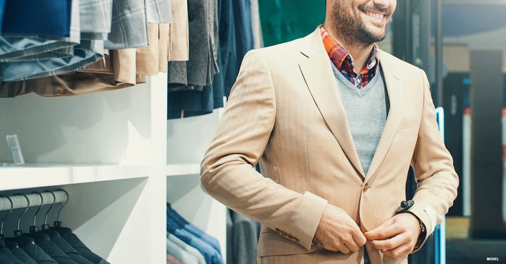 A man tries on a blazer