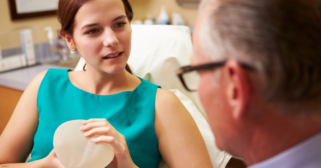 A patient asks a doctor (models) questions about what to expect with breast augmentation surgery.