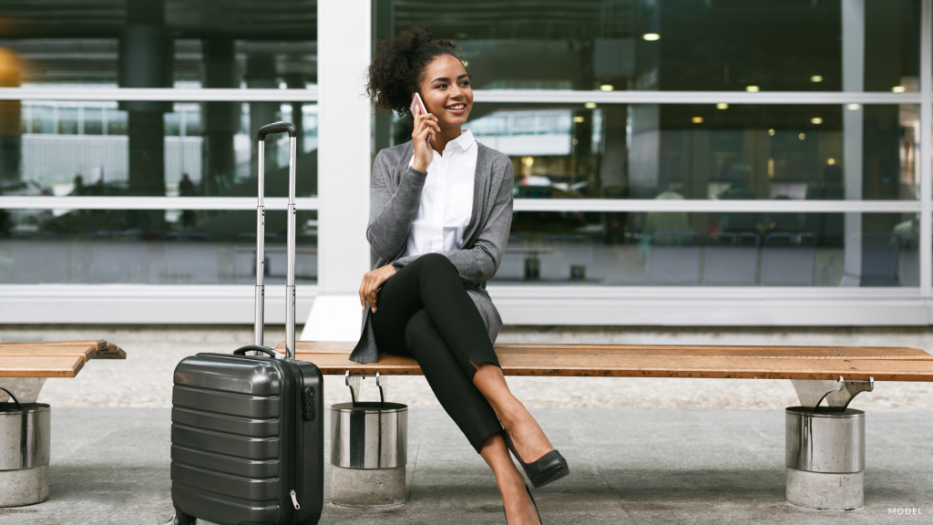 Woman at airport after Breast Augmentation Surgery in NY.